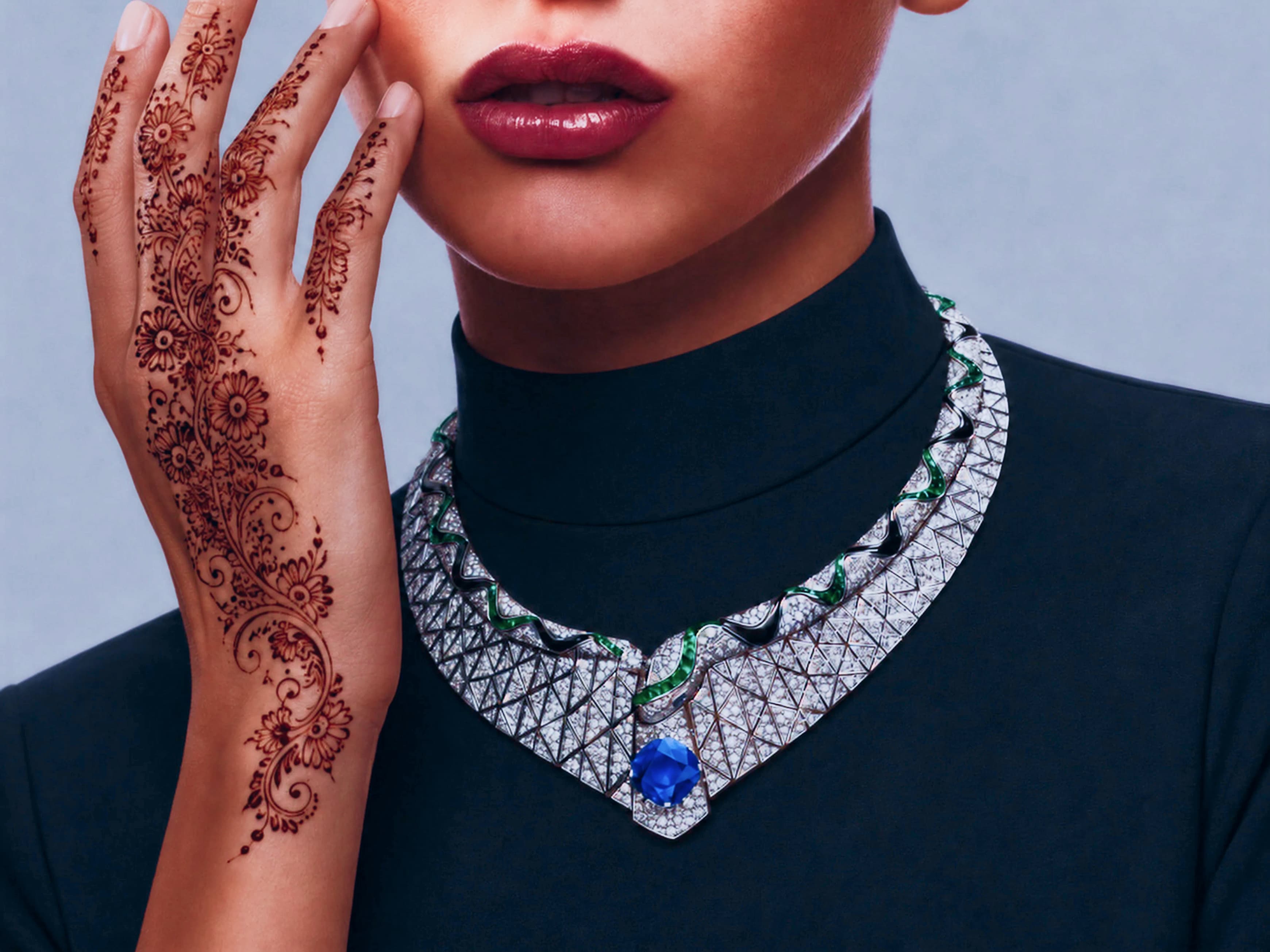 Intricate henna art on a model's hand with luxury jewellery
